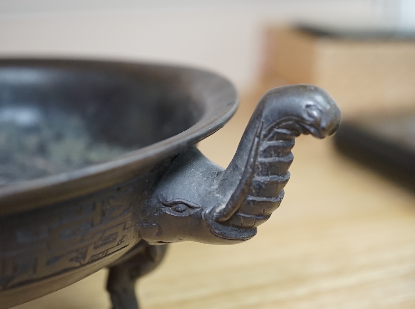 A Chinese archaistic bronze tripod ‘elephant head’ censer, Xuande mark, 19th century, 24cm handle to handle. Condition - fair to good